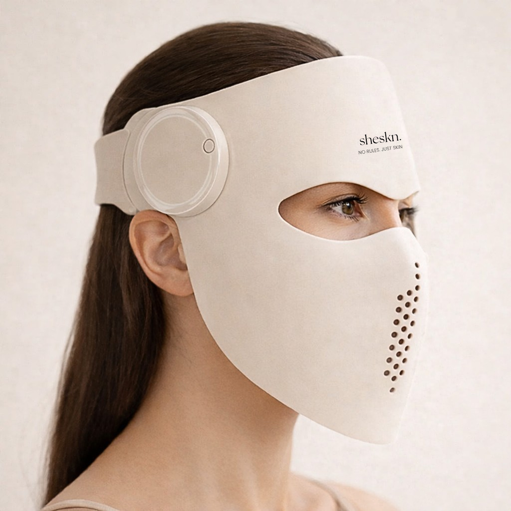 Side profile of model wearing the Sheskn Luméskn LED face mask showing ergonomic silicone design and forehead logo detail.