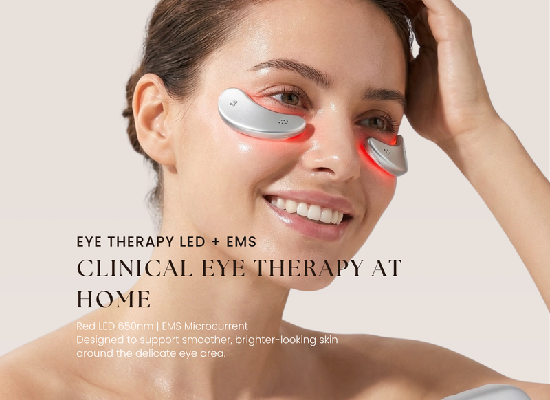 Woman using the Sheskn Eye Therapy device featuring red LED 650nm and EMS microcurrent technology designed to support smoother and brighter looking skin around the eyes.